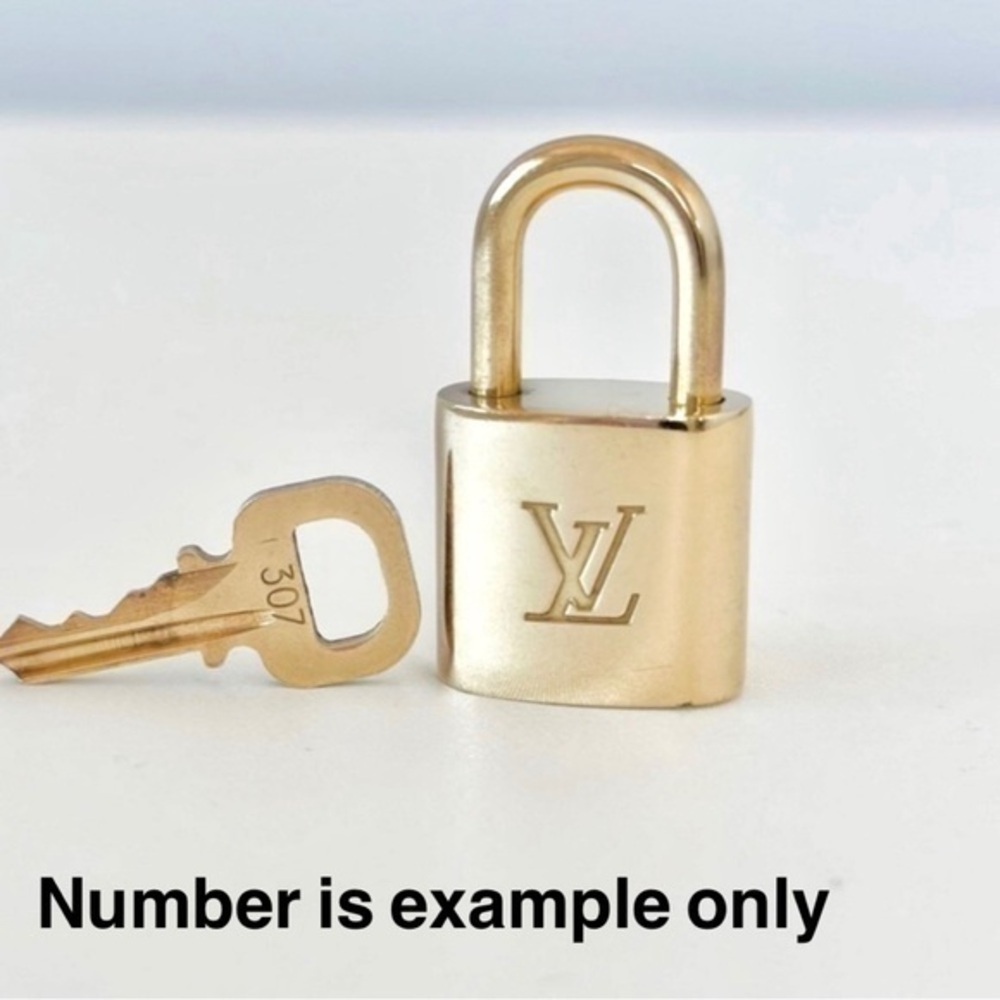 AUTHENTIC Louis Vuitton lock and key. NEAR MINT condition.